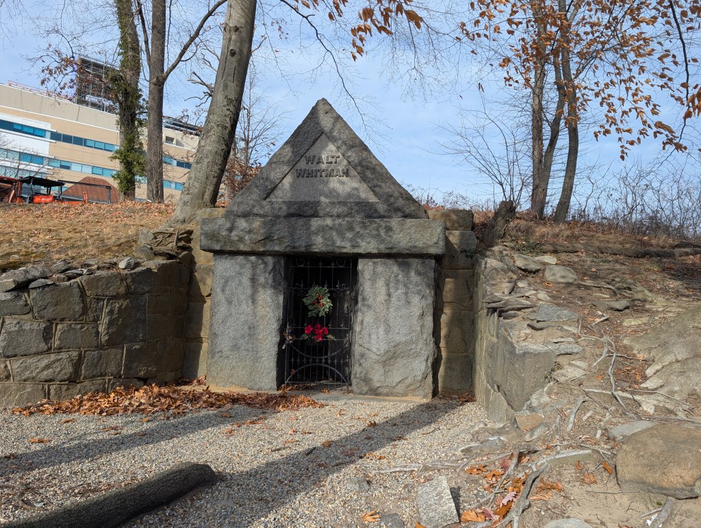 Photo of Walt Whitman's grave in Harleigh Cemetery, NJ, with a Christmas wreath placed on it