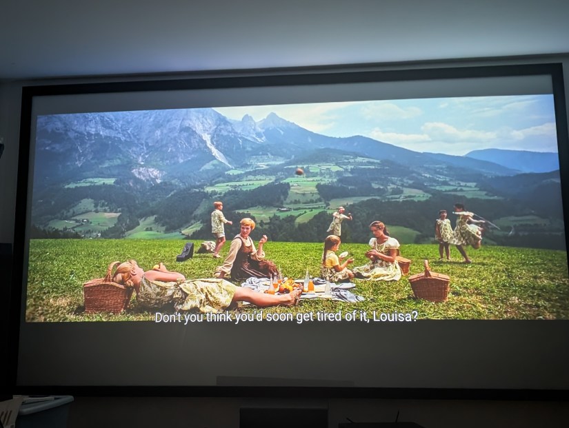 Scene from the movie The Sound of Music with Maria and the children on a picnic overlooking the Alps
